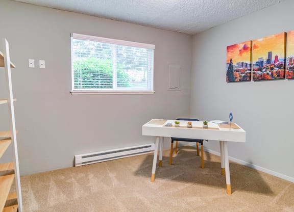 a bedroom with a bed and a desk in front of a window at The Bluffs at Mountain Park, Oregon