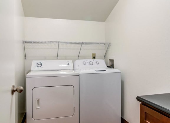 a washer and dryer in a room at The Bluffs at Mountain Park, Lake Oswego