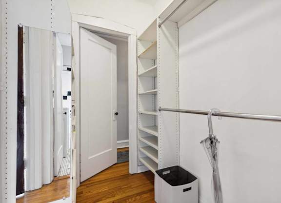 a room with a closet and a trash can in it at The Bryant at Oak Park I & II, Oak Park, IL 60302