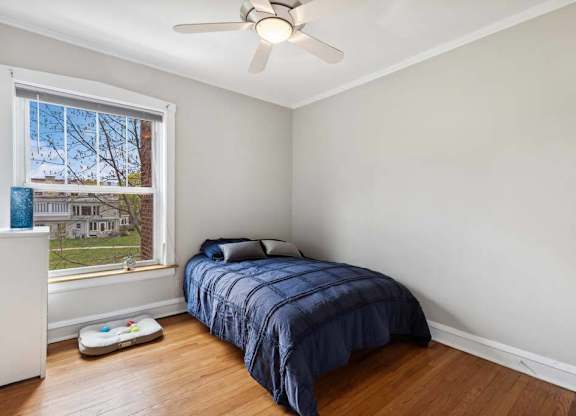 a bedroom with a bed and a ceiling fan at The Bryant at Oak Park I & II, Oak Park, IL