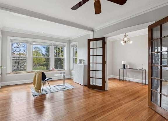 the living room has a hardwood floor and a large window at The Bryant at Oak Park I & II, Oak Park, 60302
