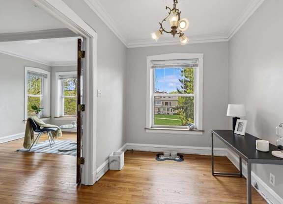 a living room with a window and a table at The Bryant at Oak Park I & II, Oak Park Illinois