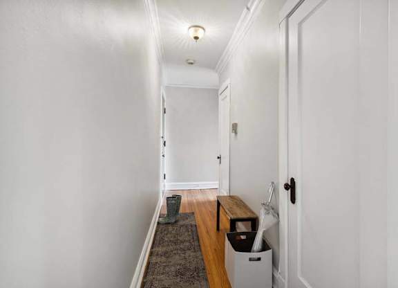 a hallway with white walls and a wooden floor at The Bryant at Oak Park I & II, Oak Park Illinois