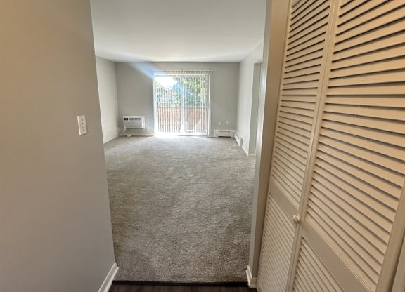 a view of a living room from a hallway with closet doors at River Oaks, North Aurora, IL, 60542