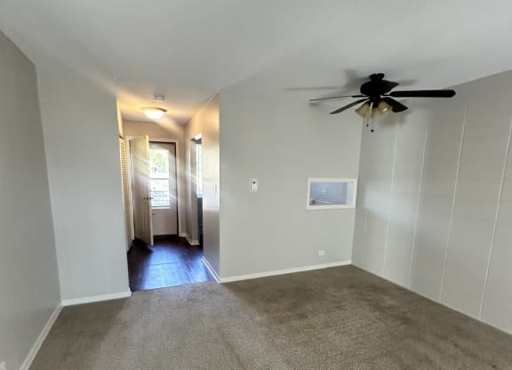a living room with carpet and a ceiling fan  at River Oaks, North Aurora, Illinois