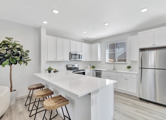 Kitchen with a large island and stainless steel refrigerator