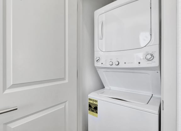 Laundry room has a washer and dryer and a door to the closet