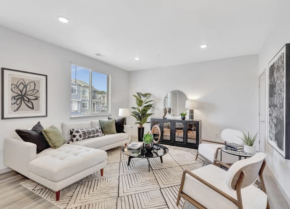 Living room with couch, chairs, and a table