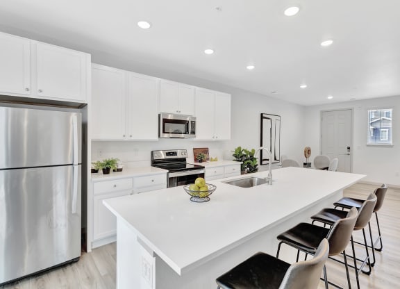 Kitchen with a white counter top and large island