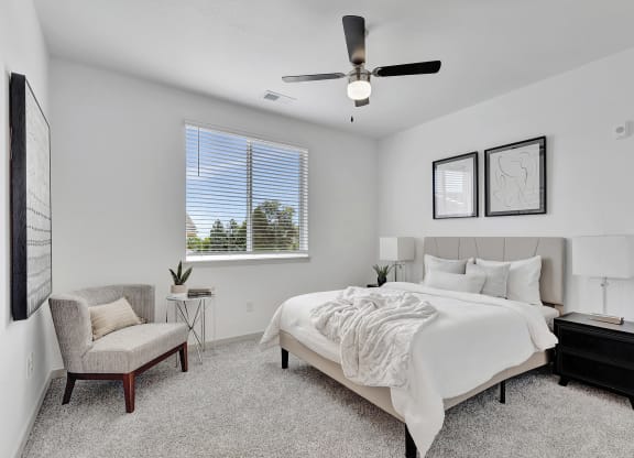 Bedroom with a large bed and a ceiling fan
