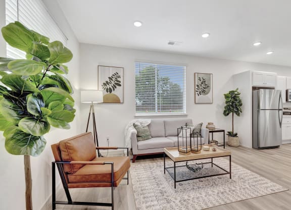 Living room and kitchen with a refrigerator and a couch