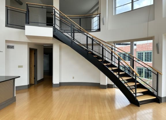 a staircase in with wood floors at The Flats at Southside