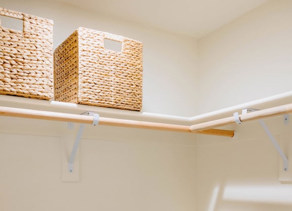 a walk in closet with wicker baskets and white shelves at Arrive Paso Robles, Paso Robles