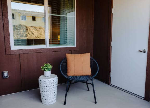 a chair and a plant on a porch in front of a door  at Arrive Paso Robles, Paso Robles, 93446