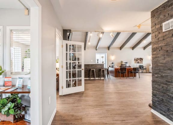 a living room with a fireplace and a ceiling with exposed beams at ReNew Odenton, Odenton, Maryland
