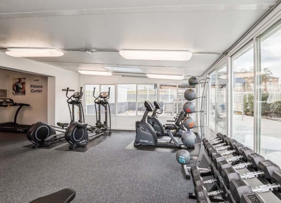 a gym with a lot of exercise equipment and windows at ReNew Odenton, Odenton, Maryland