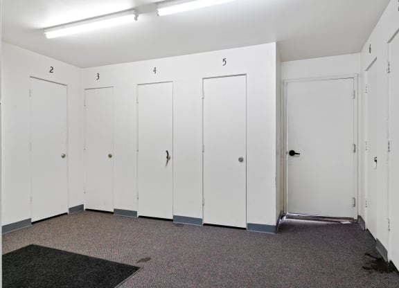a row of white lockers in a room with a carpeted floor  at ReNew Eagle River, Eagle River, AK