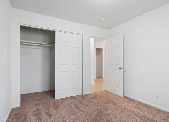 a bedroom with two closets and a carpeted floor  at ReNew Eagle River, Alaska, 99577