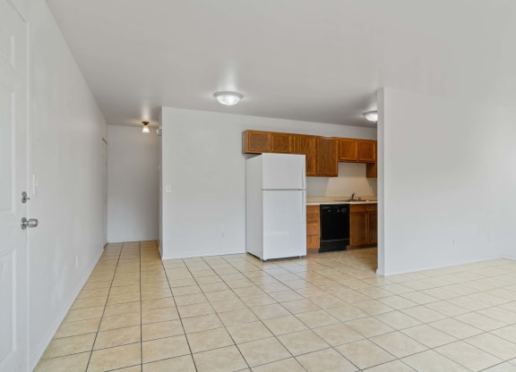 a kitchen with a white refrigerator freezer next to a black dishwasher at ReNew Eagle River, Eagle River, Alaska