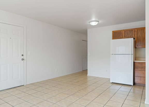 a kitchen with a white refrigerator freezer next to a doorway at ReNew Eagle River, Eagle River, AK, 99577