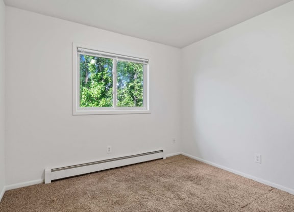 a bedroom with white walls and a window at ReNew Eagle River, Eagle River, AK