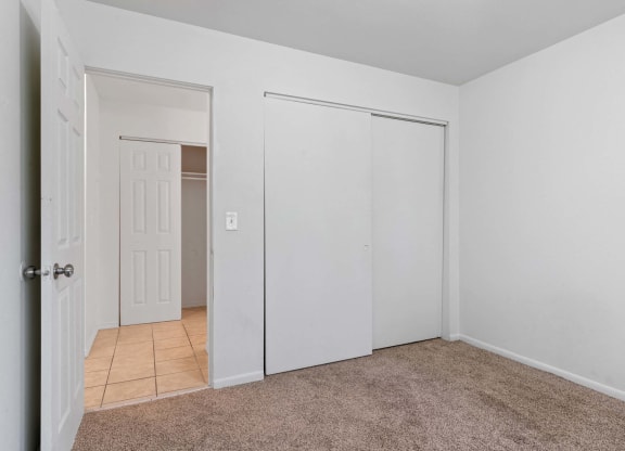 a bedroom with a large closet and a tiled floor at ReNew Eagle River, Eagle River, AK, 99577