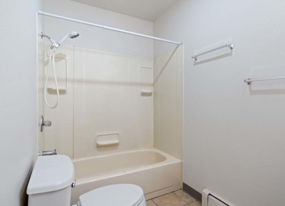 a bathroom with a toilet and a bathtub at ReNew Eagle River, Alaska, 99577
