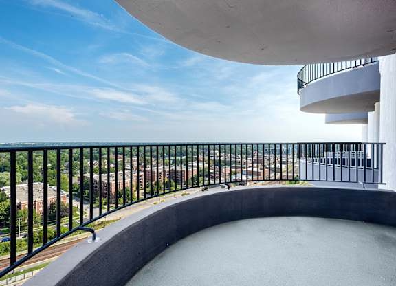 A balcony with a black railing overlooks a cityscape.at ReNew Wheaton Center, Wheaton, IL