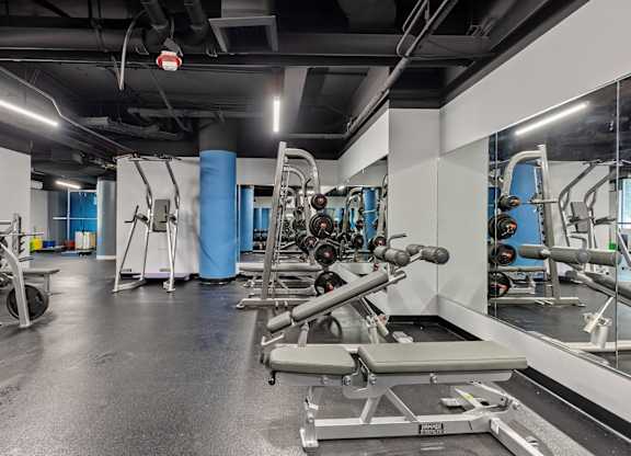 A gym with a variety of equipment including weights and a bench.at ReNew Wheaton Center, Wheaton Illinois