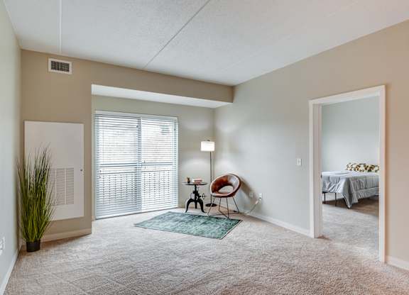 A room with a chair and a table in it.