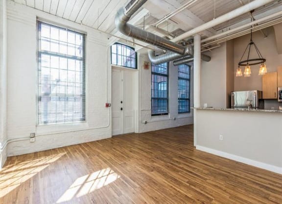 Room with wooden flooring and kitchen at Rising Sun Mills, Providence, Rhode Island