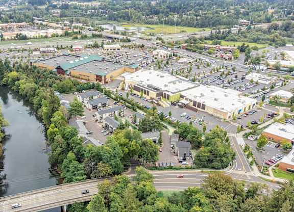 A river flows through a city with a bridge crossing over it. at River Lofts Apartments, Tualatin, Oregon