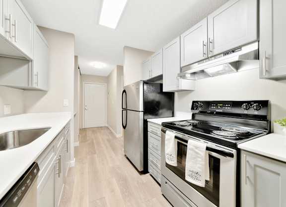 A modern kitchen with a black stove top oven. at River Lofts Apartments, Tualatin