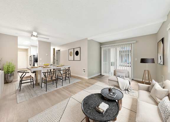 A living room with a dining table and chairs.