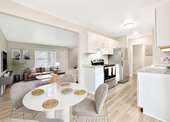 A modern kitchen with a dining table set for two.