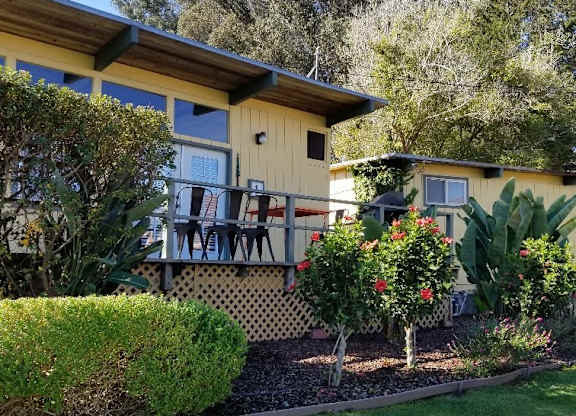 yellow cabin with deck and landscaping at Salinas Sunset Apartments, California, 93907
