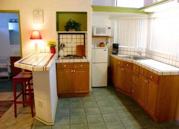 A kitchen with a white fridge at Salinas Sunset Apartments, California