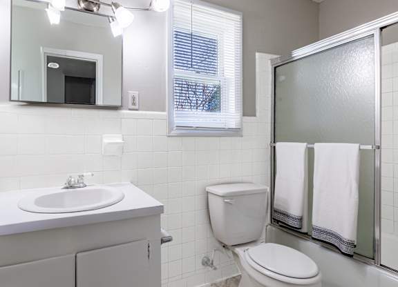 a white bathroom with a shower toilet and sink at Sharon West, Charlotte, 28210