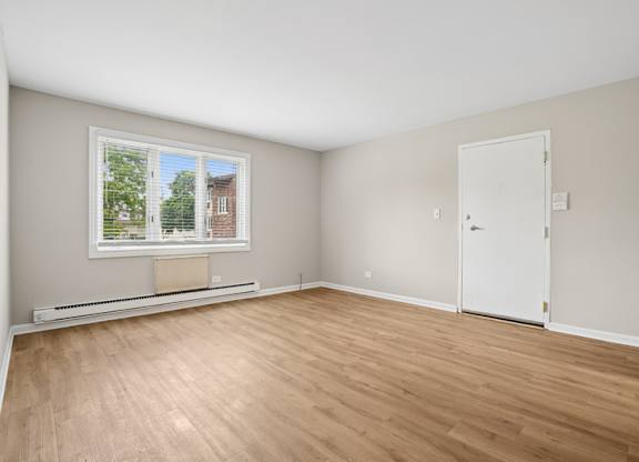 A living room with a window and a door.