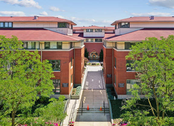 A red brick building with a walkway in front.