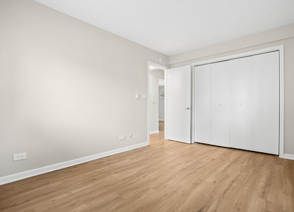 A room with a white door and a white wall.