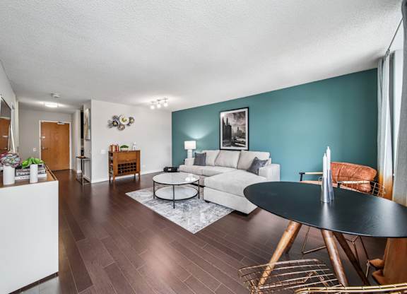 A living room with a white sofa and a black coffee table.