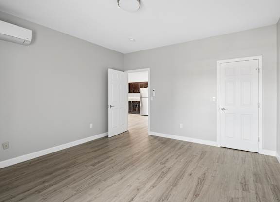 A room with white doors and a wooden floor.