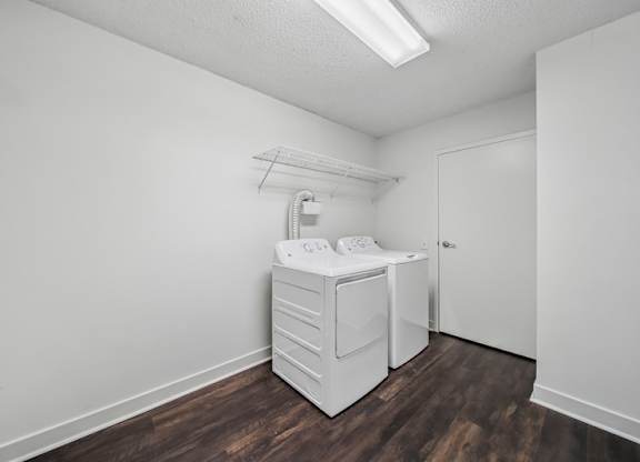A white baby changing station in a room with wood flooring.