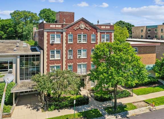 A red brick building with a balcony on the second floor.