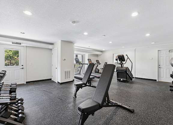 Fitness center with a variety of equipment including weights and exercise machines.