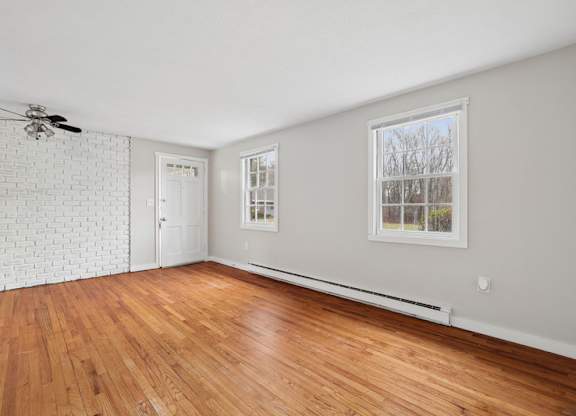 A room with wooden floors and white walls.