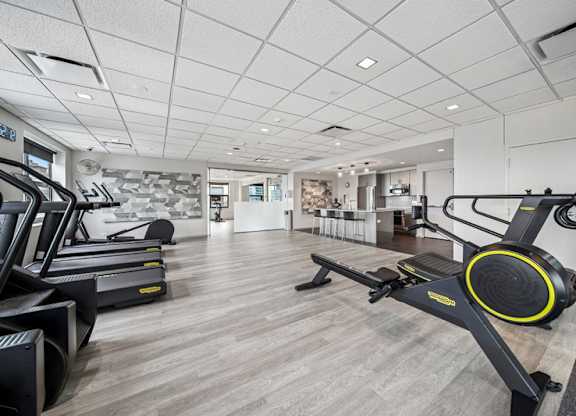 A gym with treadmills and elliptical machines.