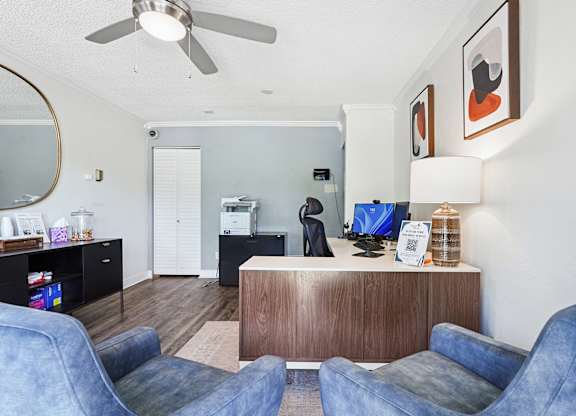 A living room with a blue couch and a wooden cabinet.