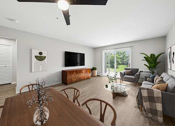 A modern living room with a wooden dining table and brown chairs.
